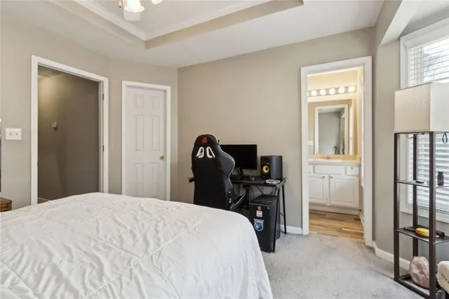 a bedroom with a bed and a flat tv screen on a dresser