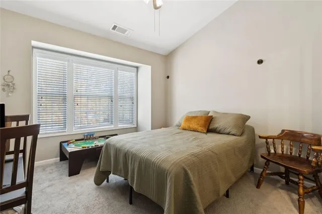 a bedroom with a bed and a table