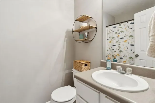 a bathroom with a sink a toilet and a mirror