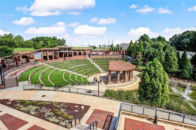 a view of a swimming pool with a chairs and tables in the patio