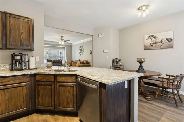 a kitchen with a sink a stove and cabinets