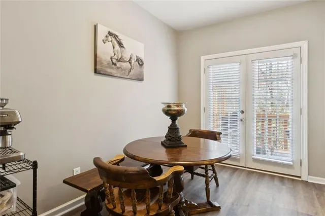 a dining room with furniture and wooden floor