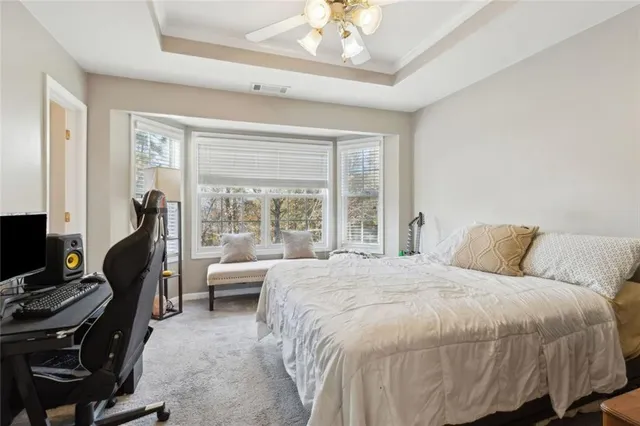 a bedroom with a bed and a large window