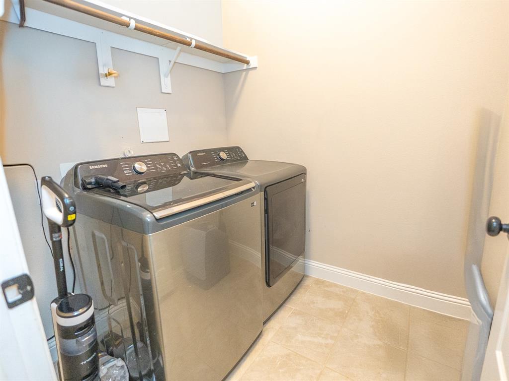 216 Nathan Drive Princeton, TX 75407 - Photo 7 of 12 a utility room with water heater and white cabinets