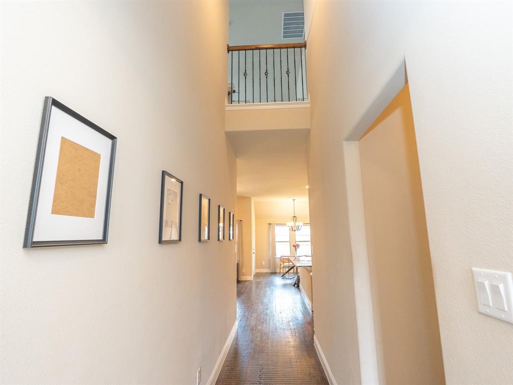 216 Nathan Drive Princeton, TX 75407 - Photo 10 of 12 a view of a hallway with wooden floor and cabinet