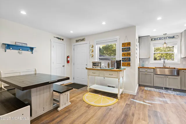 a kitchen with a wooden floor and a refrigerator