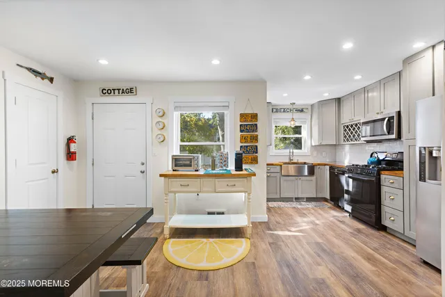 a living room with wooden floor and furniture