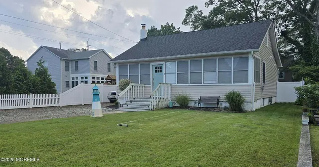 a view of a house with a yard and sitting area