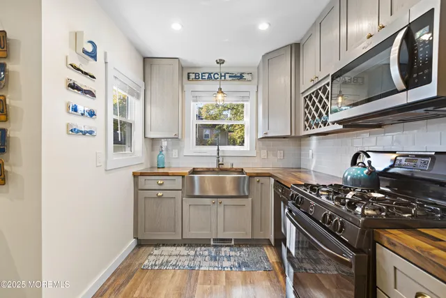 a kitchen with stainless steel appliances granite countertop a sink stove and cabinets