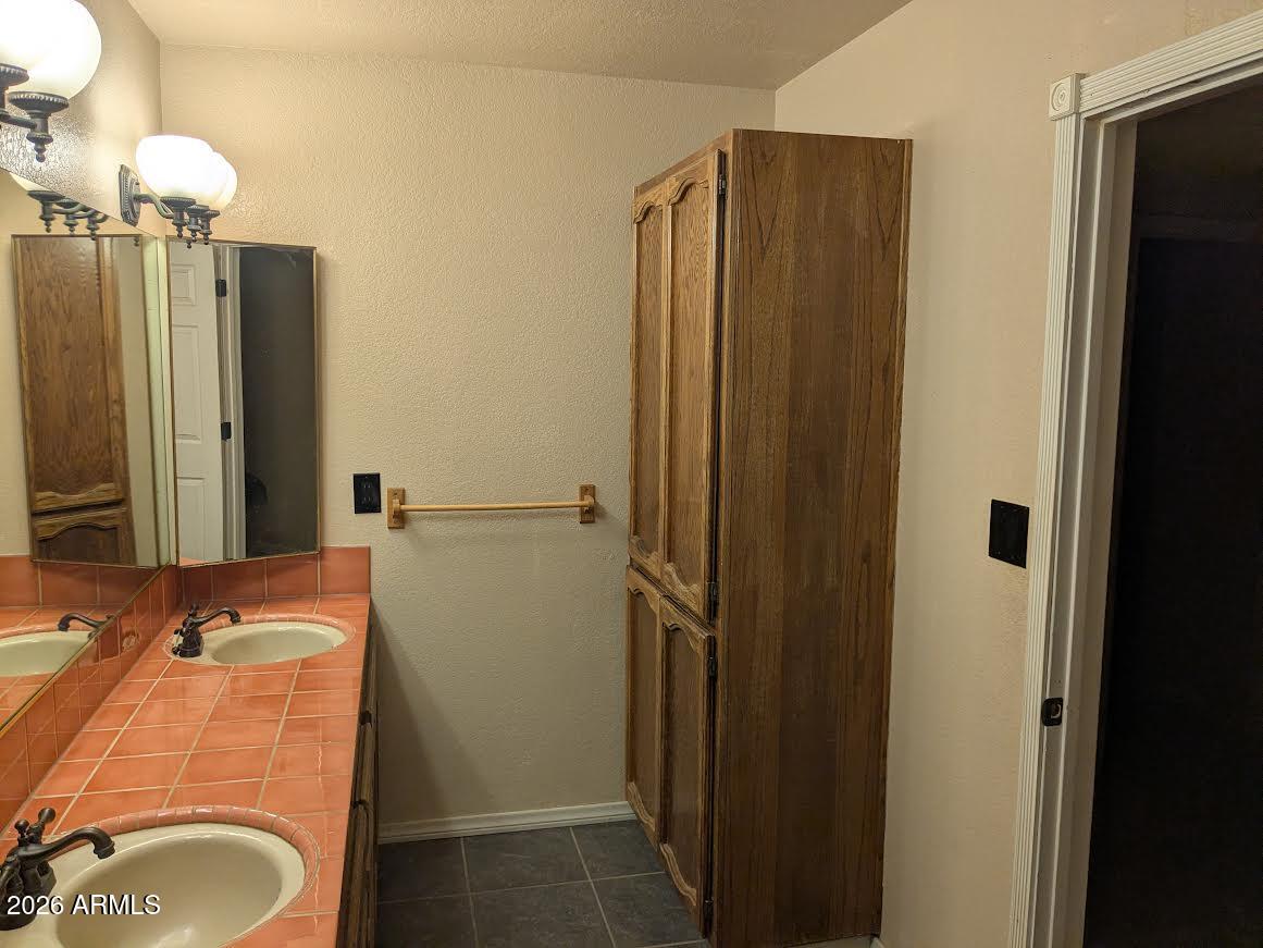 1341 North Pomeroy Mesa, AZ 85201 - Photo 23 of 32 a bathroom with a sink and mirror