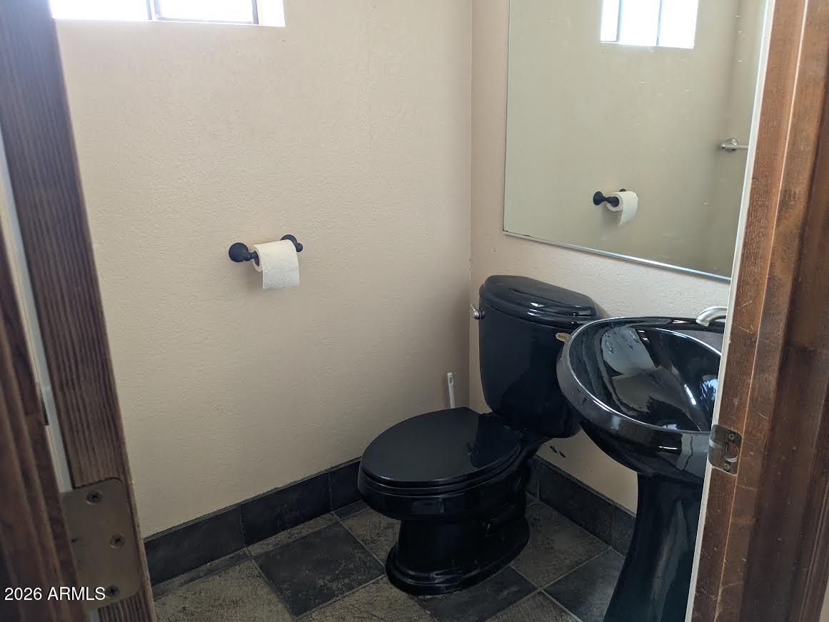 1341 North Pomeroy Mesa, AZ 85201 - Photo 26 of 32 a bathroom with a toilet and a sink