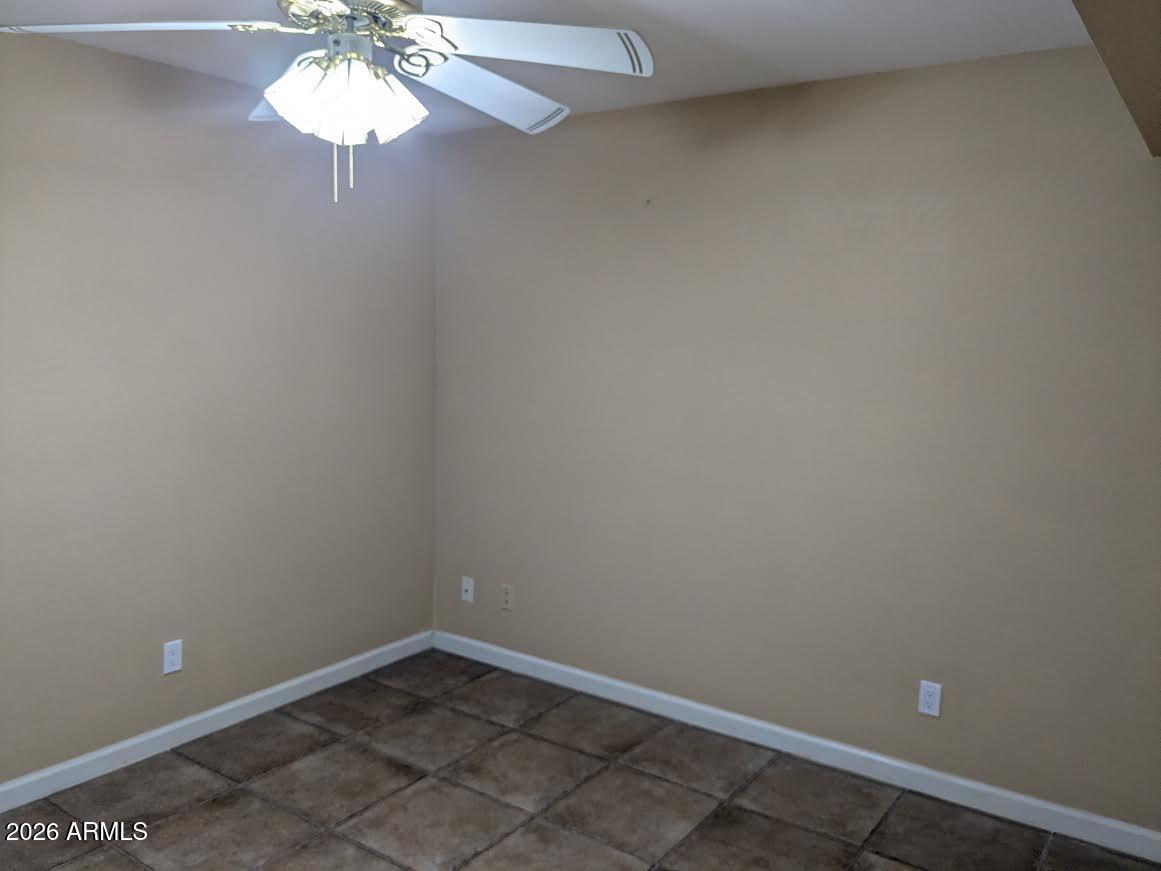 1341 North Pomeroy Mesa, AZ 85201 - Photo 28 of 32 an empty room with a chandelier fan