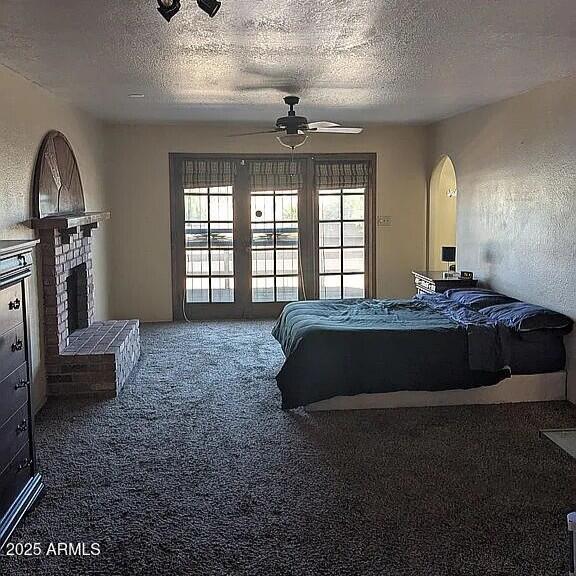 1341 North Pomeroy Mesa, AZ 85201 - Photo 10 of 32 a spacious bedroom with a bed lamp and a fireplace