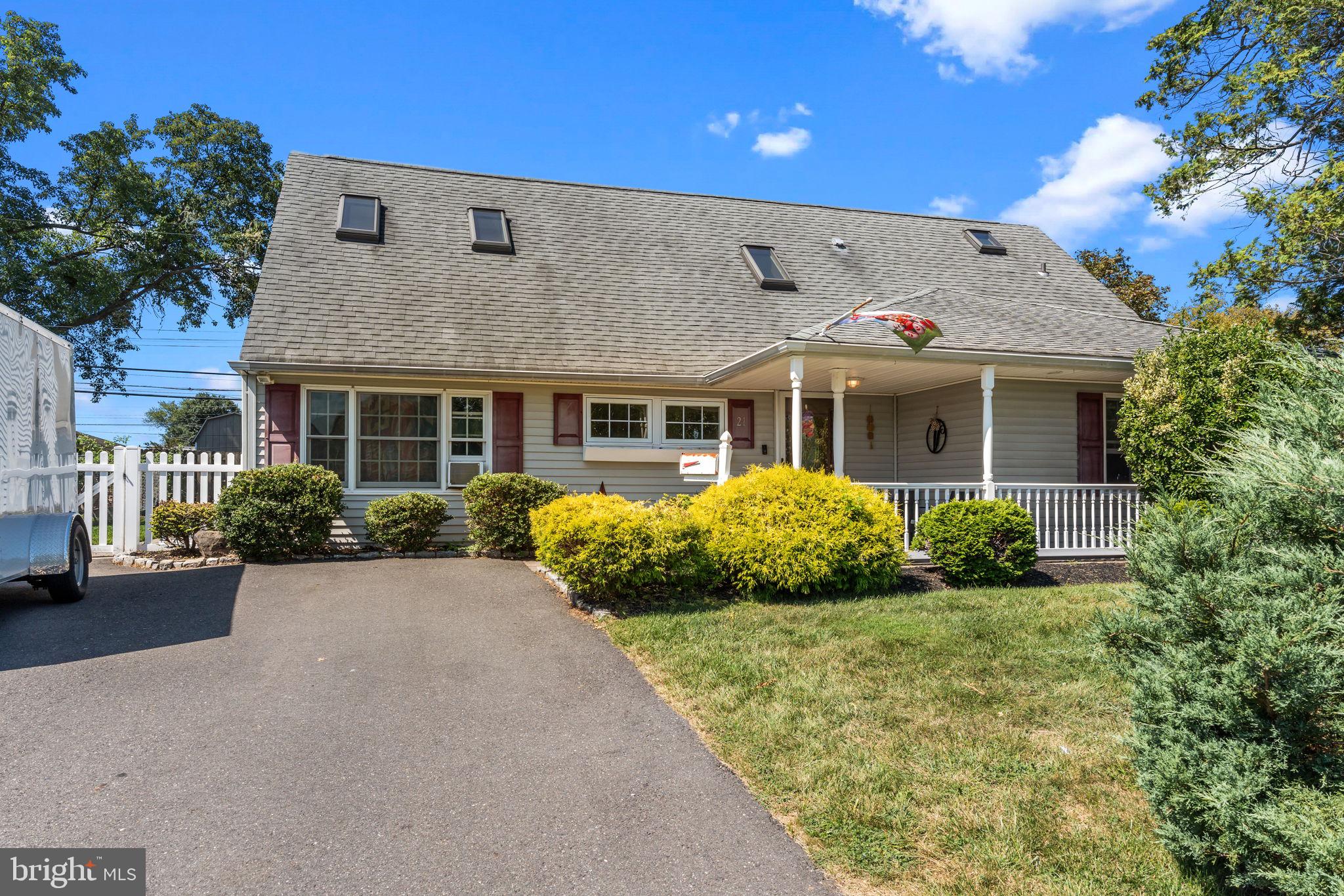 21 Downhill Road Levittown, PA 19056 - Photo 1 of 28 a front view of a house with a garden and plants