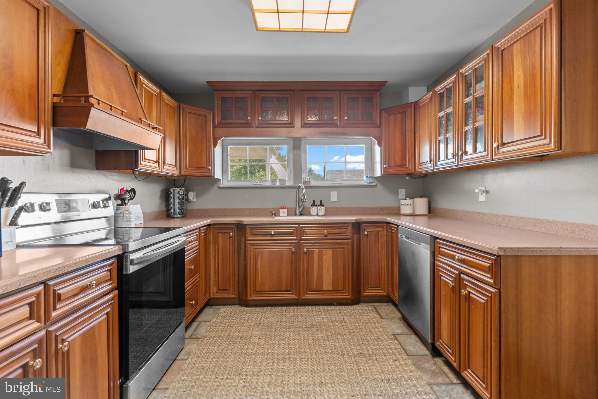 21 Downhill Road Levittown, PA 19056 - Photo 11 of 28 a kitchen with stainless steel appliances granite countertop a stove a sink and a microwave
