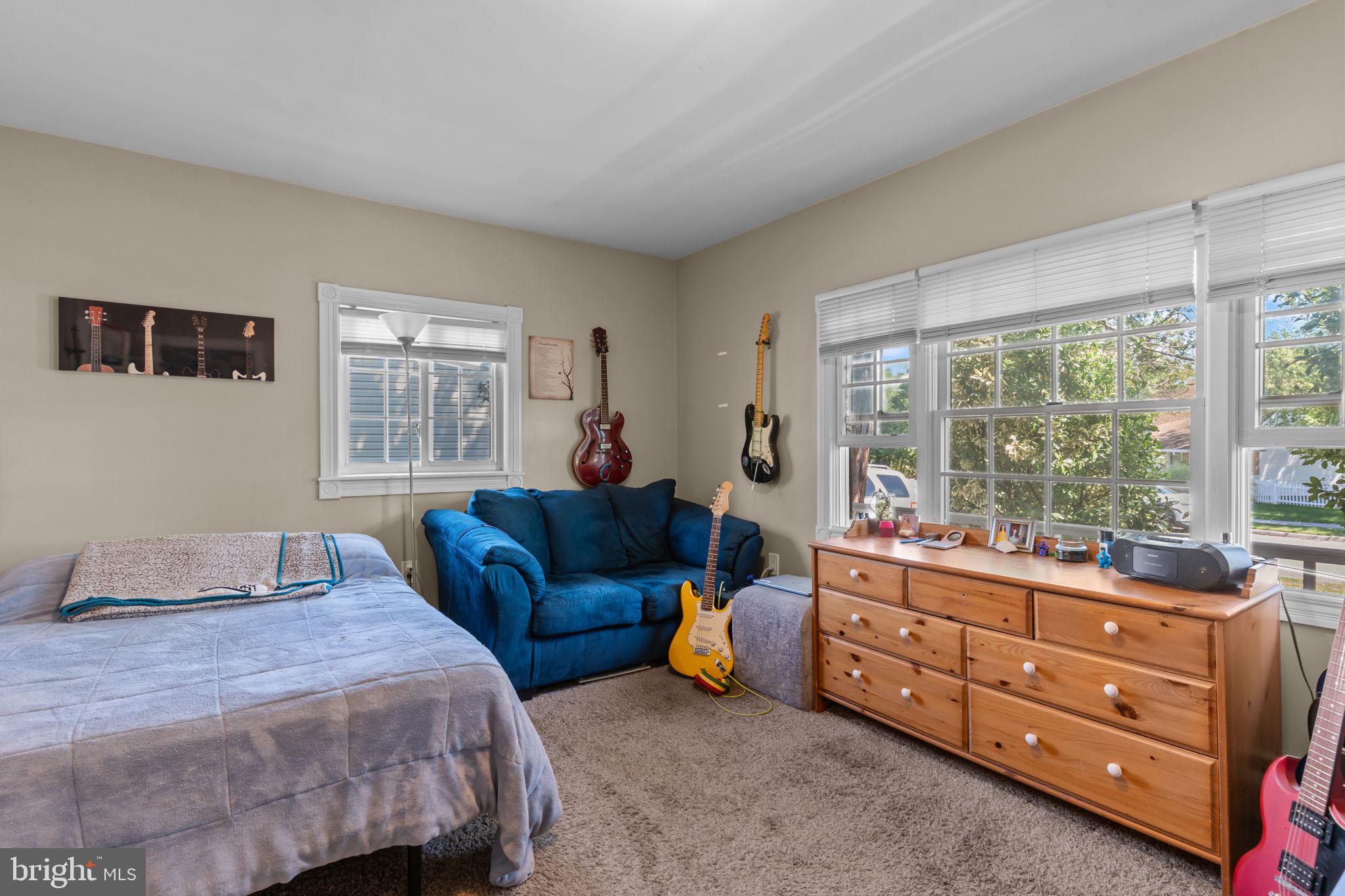 21 Downhill Road Levittown, PA 19056 - Photo 17 of 28 a bedroom with a bed and a couch next to a window