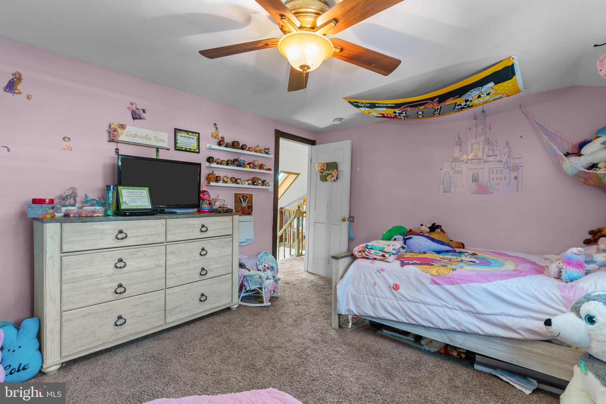 21 Downhill Road Levittown, PA 19056 - Photo 20 of 28 a bedroom with a bed and a chandelier