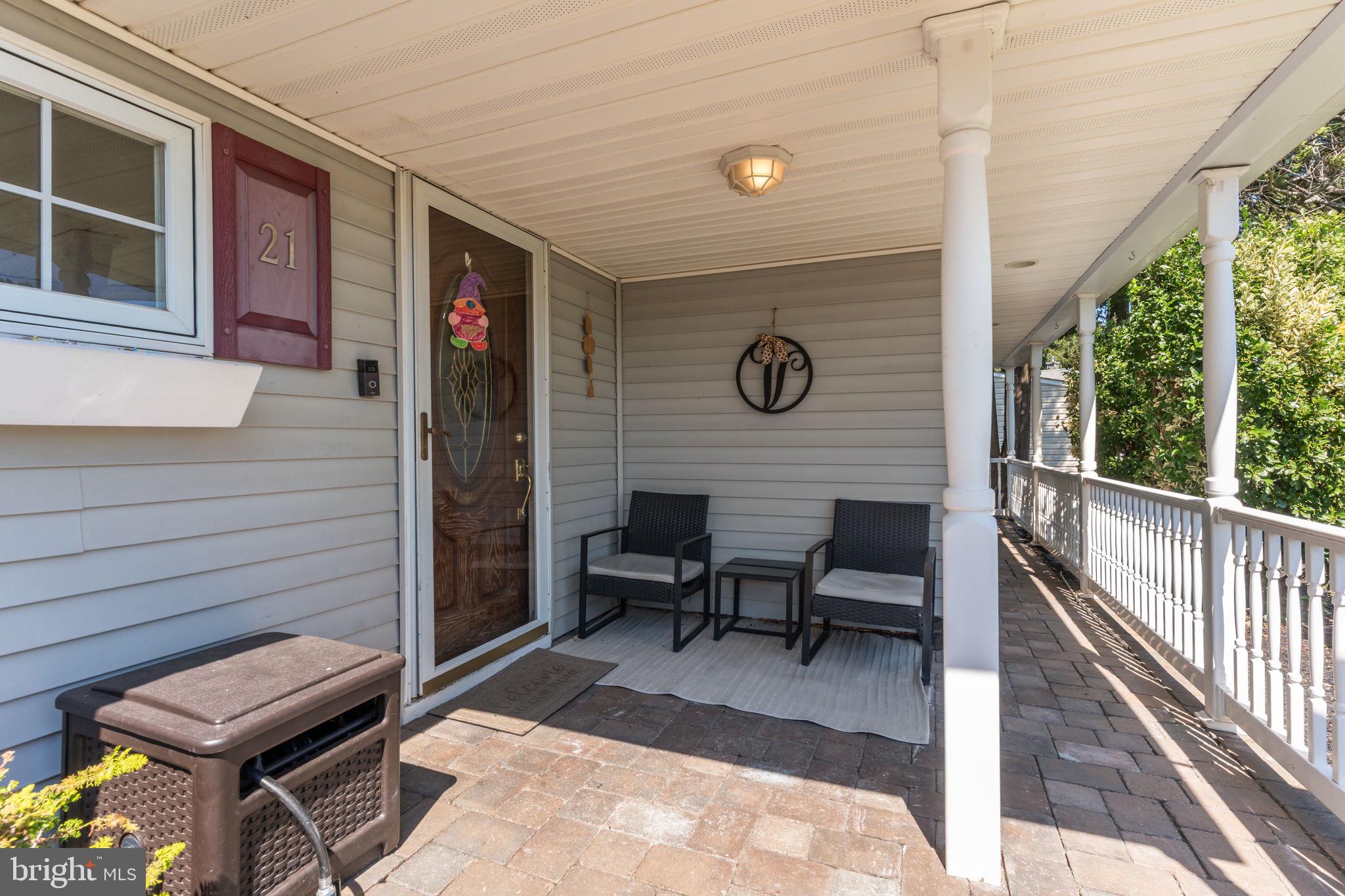 21 Downhill Road Levittown, PA 19056 - Photo 2 of 28 a view of a patio with table and chairs with wooden floor and fence