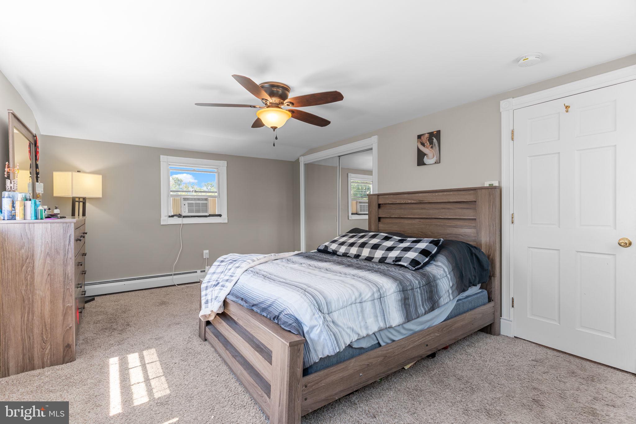 21 Downhill Road Levittown, PA 19056 - Photo 23 of 28 a bedroom with a bed and a chandelier