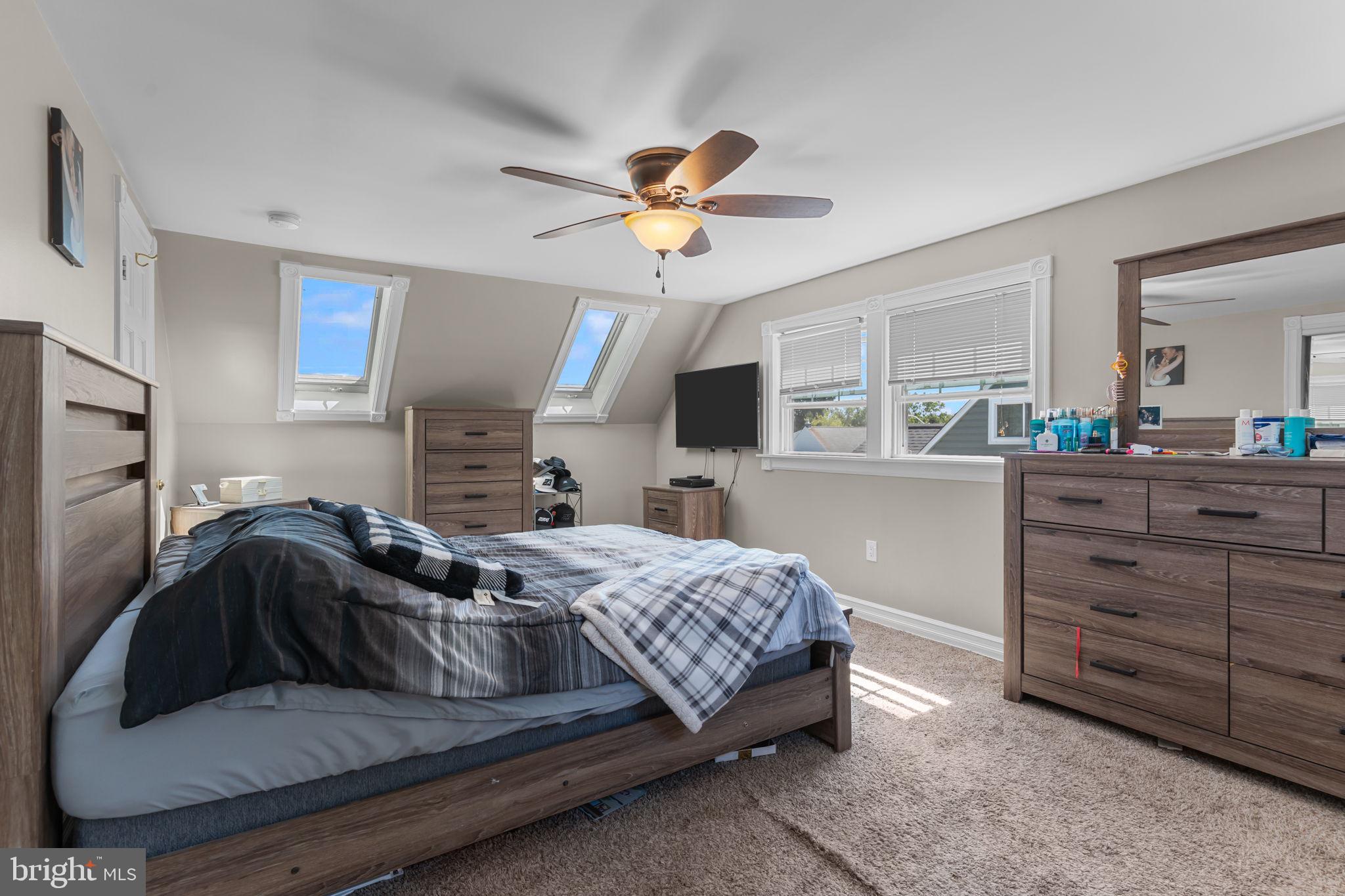 21 Downhill Road Levittown, PA 19056 - Photo 24 of 28 a bedroom with a bed and a chandelier