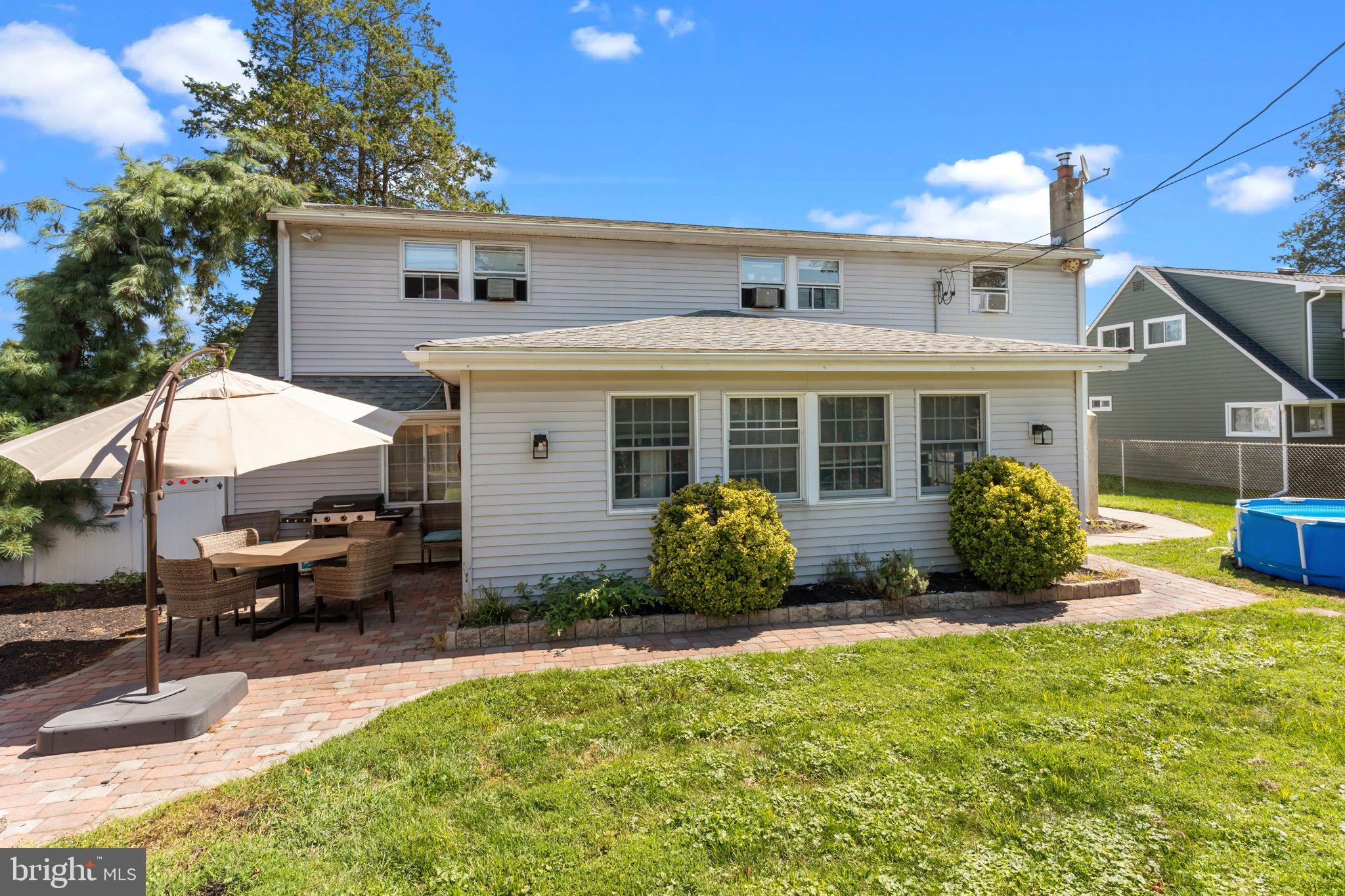 21 Downhill Road Levittown, PA 19056 - Photo 26 of 28 a view of a house with backyard sitting area and garden
