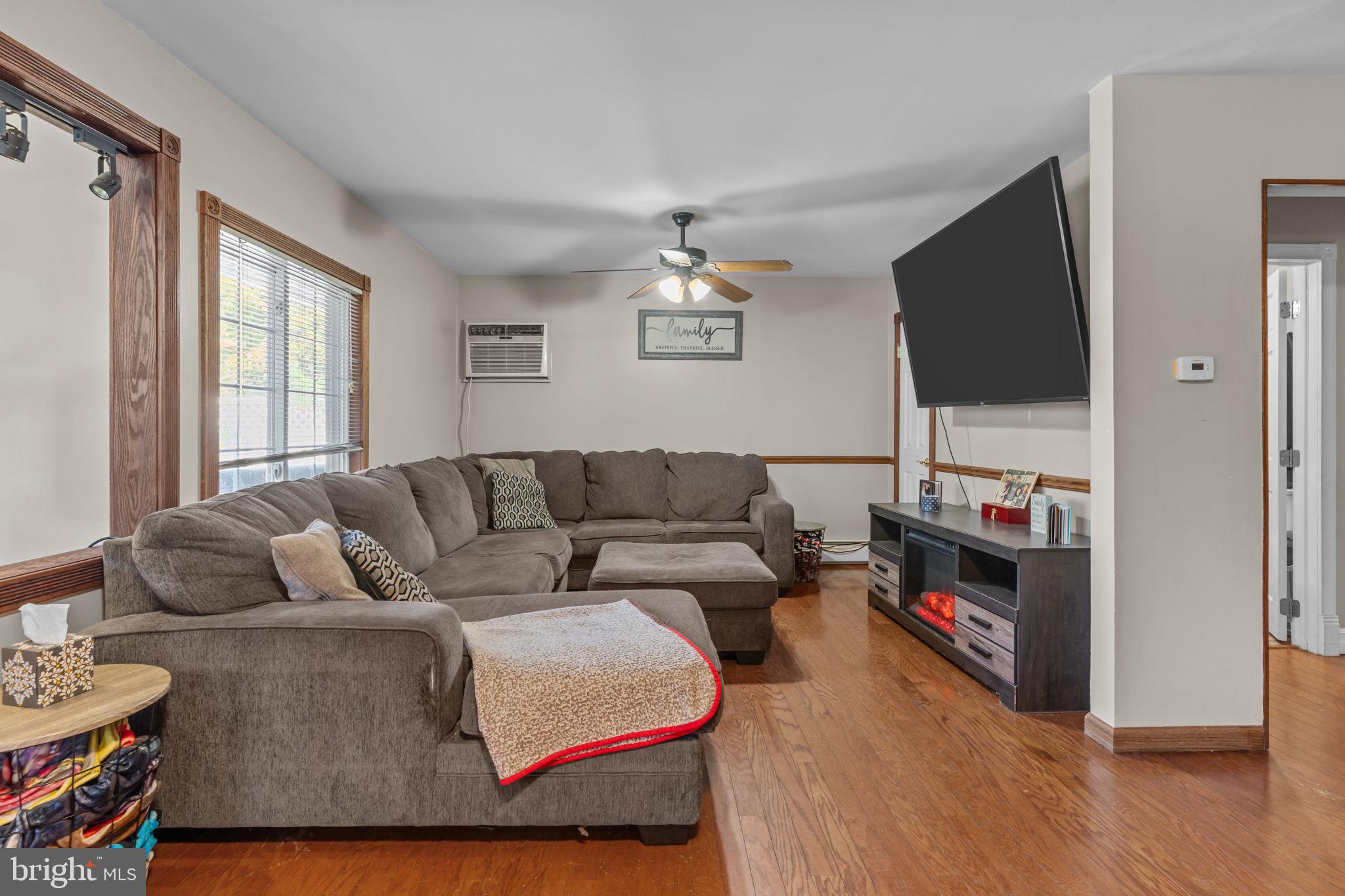 21 Downhill Road Levittown, PA 19056 - Photo 5 of 28 a living room with furniture and a flat screen tv