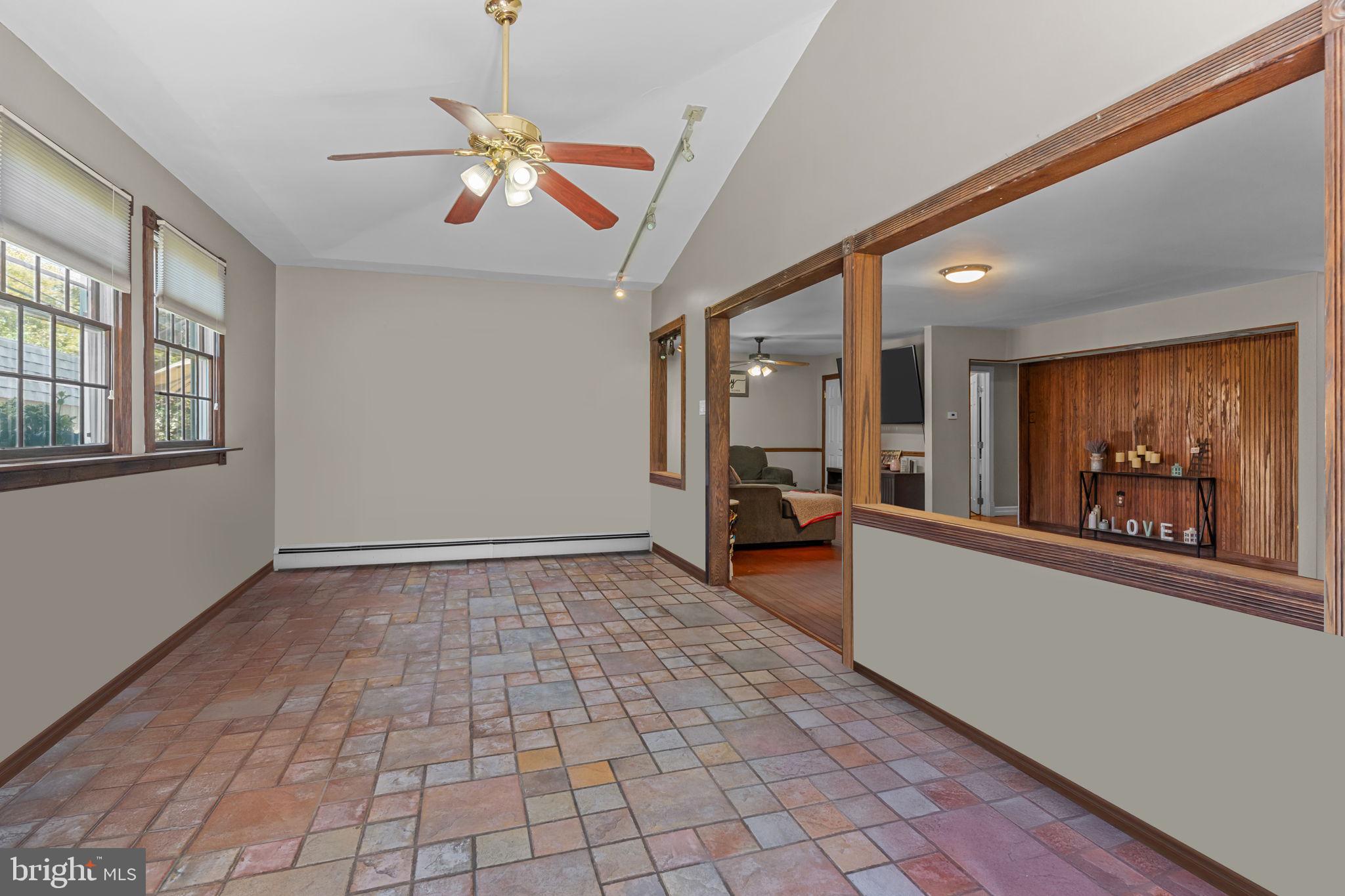 21 Downhill Road Levittown, PA 19056 - Photo 10 of 28 a view of a hallway with wooden floor and a chandelier