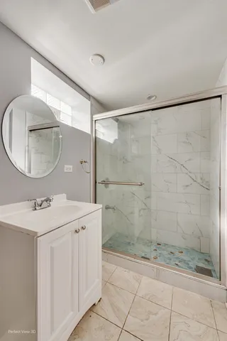 a bathroom with a sink a mirror and a shower
