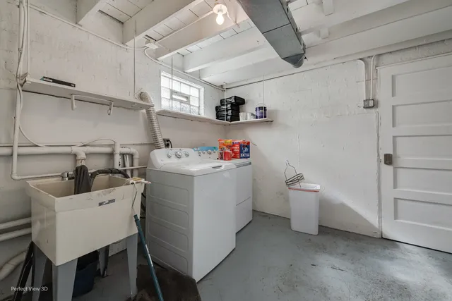 a utility room with sink dryer and washer