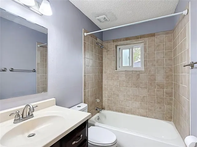 a bathroom with a sink mirror toilet and bathtub