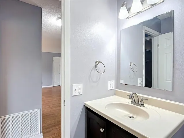 a bathroom with a sink vanity and a mirror