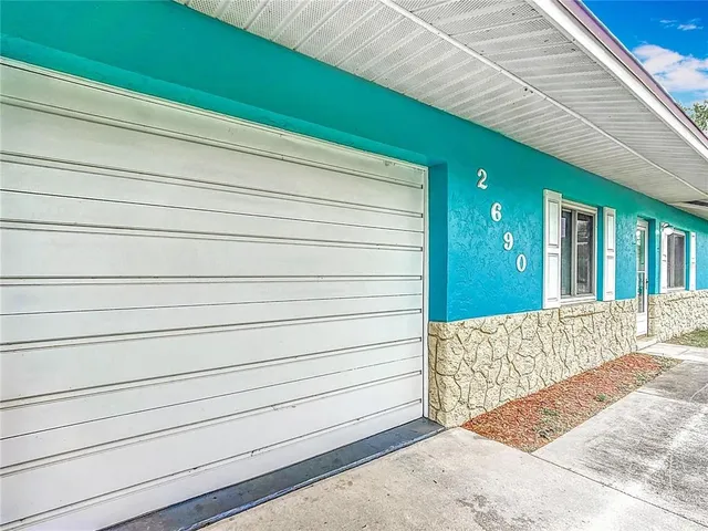 a view of wooden house with a bench
