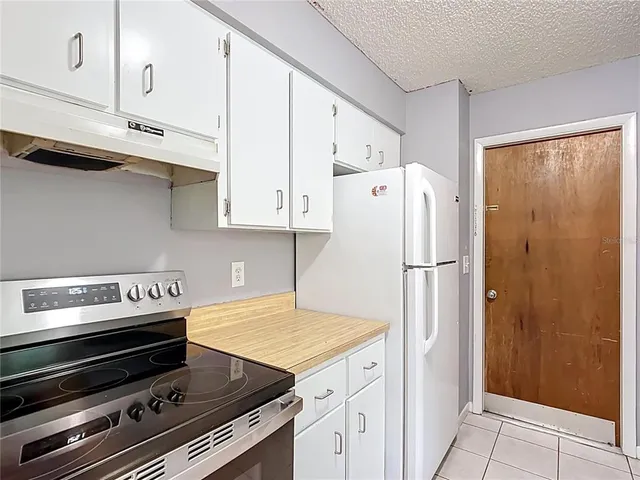 a kitchen with stainless steel appliances a refrigerator a stove and cabinets