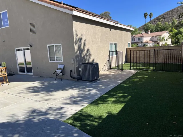 a backyard of a house with table and chairs