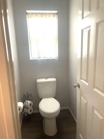 a bathroom with a toilet and a window