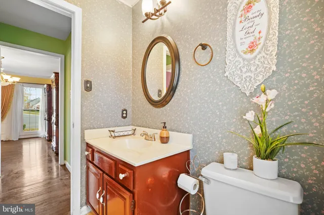 a bathroom with a toilet sink and mirror