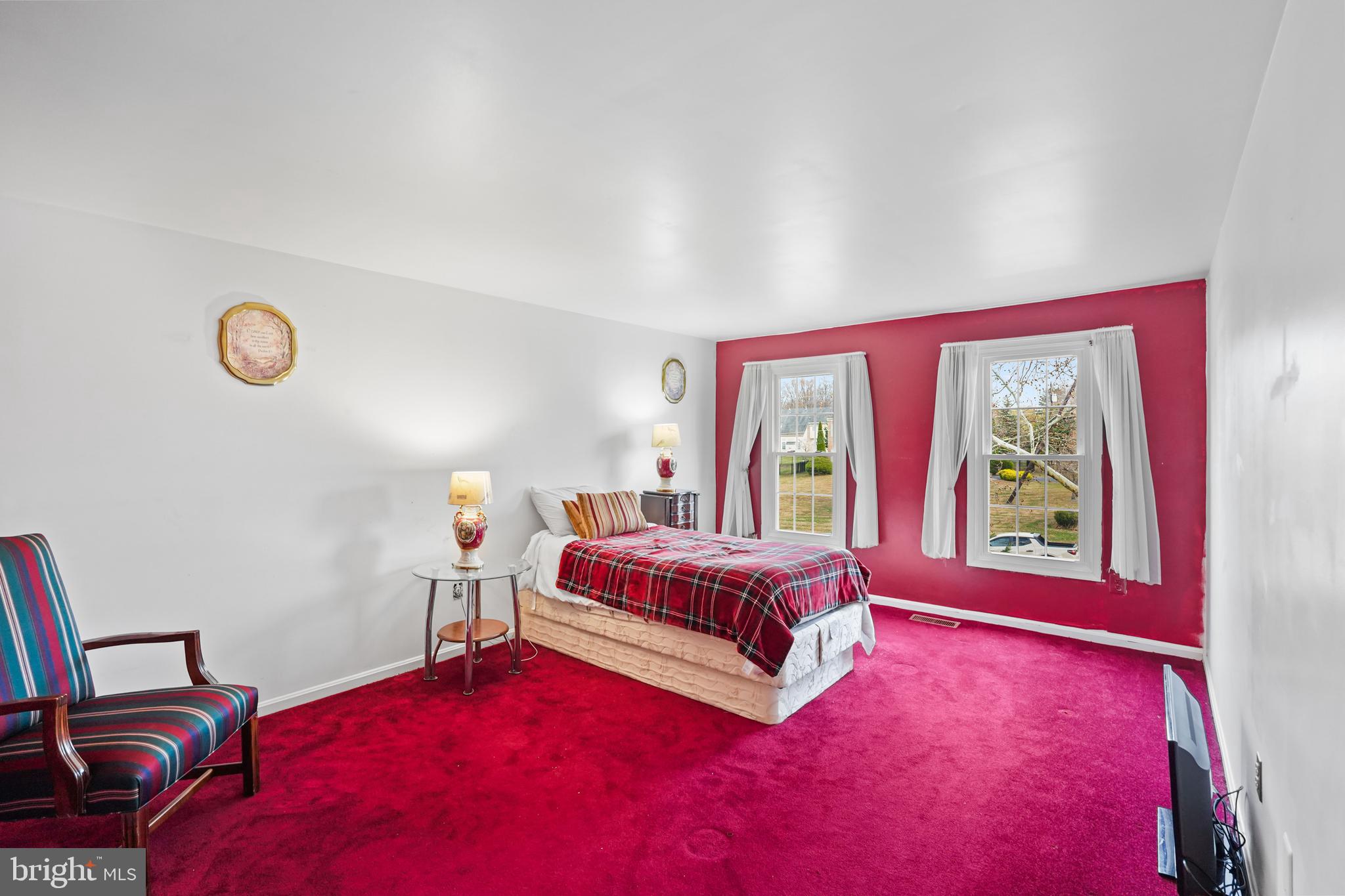 13940 Alderton Road Silver Spring, MD 20906 - Photo 15 of 41 a bedroom with a bed and wooden floor