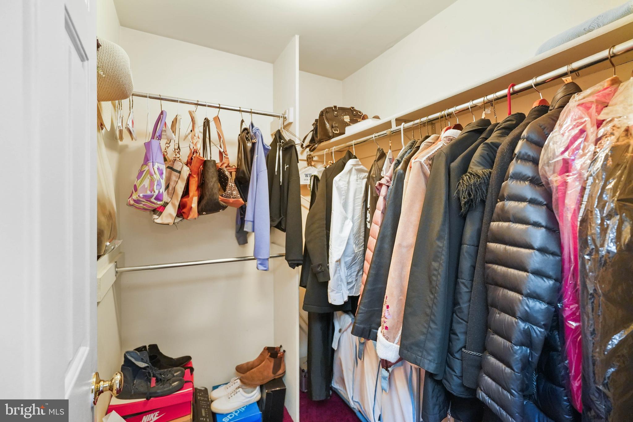 13940 Alderton Road Silver Spring, MD 20906 - Photo 24 of 41 a view of walk in closet with clothes and shoes