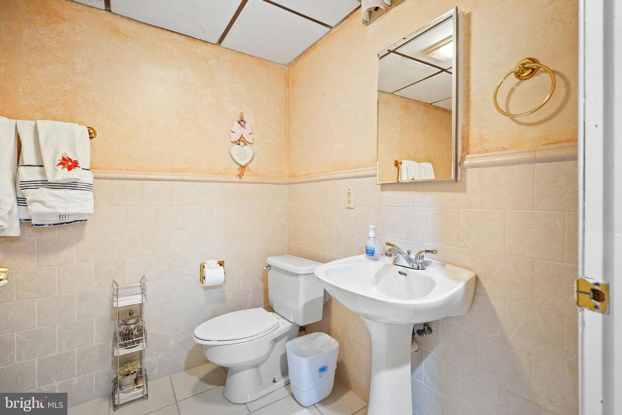 13940 Alderton Road Silver Spring, MD 20906 - Photo 26 of 41 a bathroom with a toilet sink and mirror