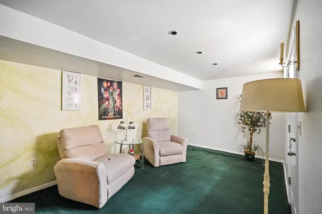 a kitchen with stainless steel appliances a refrigerator a stove a sink and a window