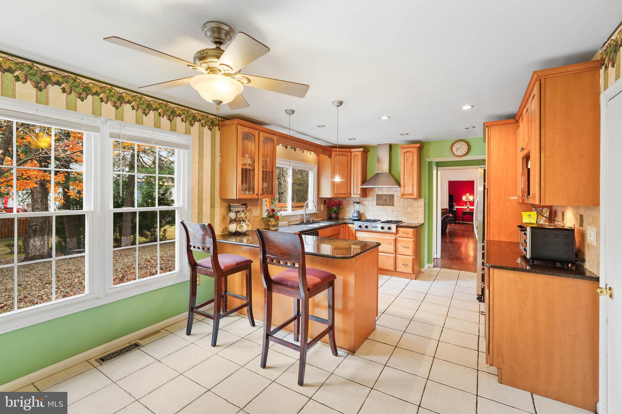 13940 Alderton Road Silver Spring, MD 20906 - Photo 3 of 41 a dining hall with stainless steel appliances kitchen island granite countertop a table and chairs in it