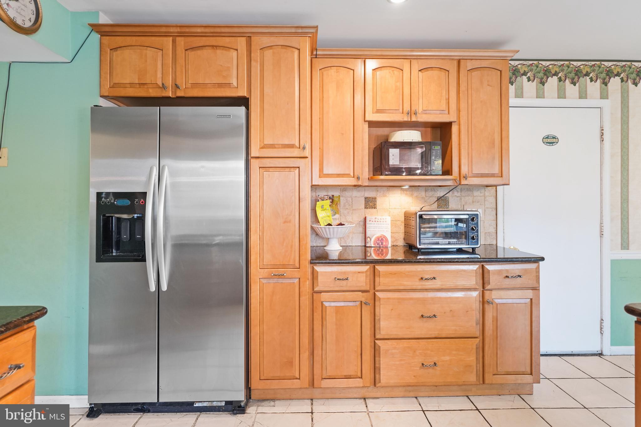 13940 Alderton Road Silver Spring, MD 20906 - Photo 6 of 41 a kitchen with stainless steel appliances granite countertop a refrigerator and a stove