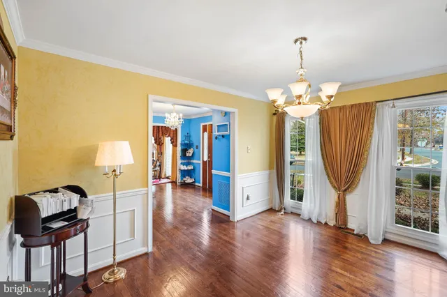 a view of a livingroom with furniture wooden floor and staircase