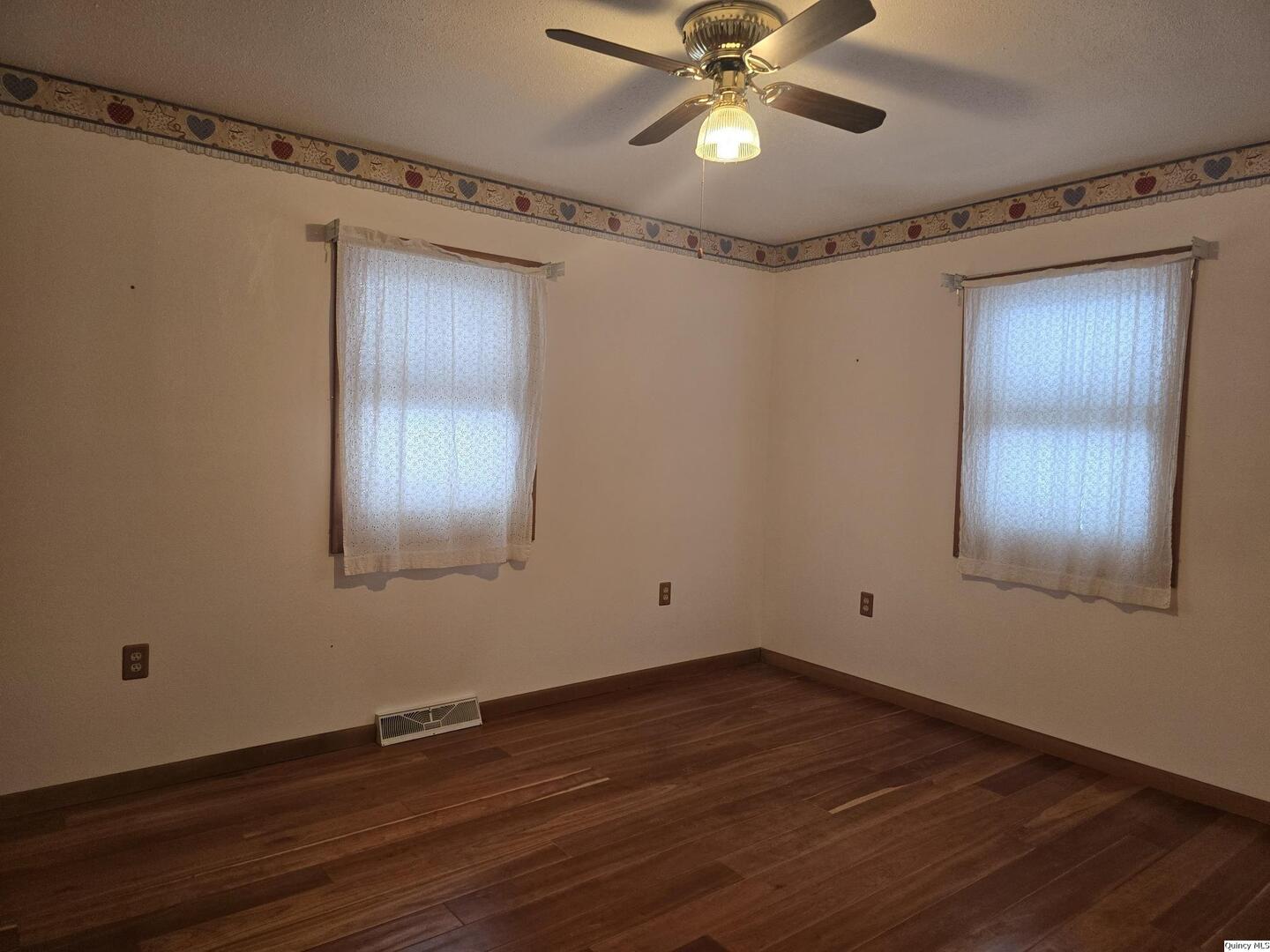 239 Rogers Road Carthage, IL 62321 - Photo 13 of 23 a view of an empty room with wooden floor and a window