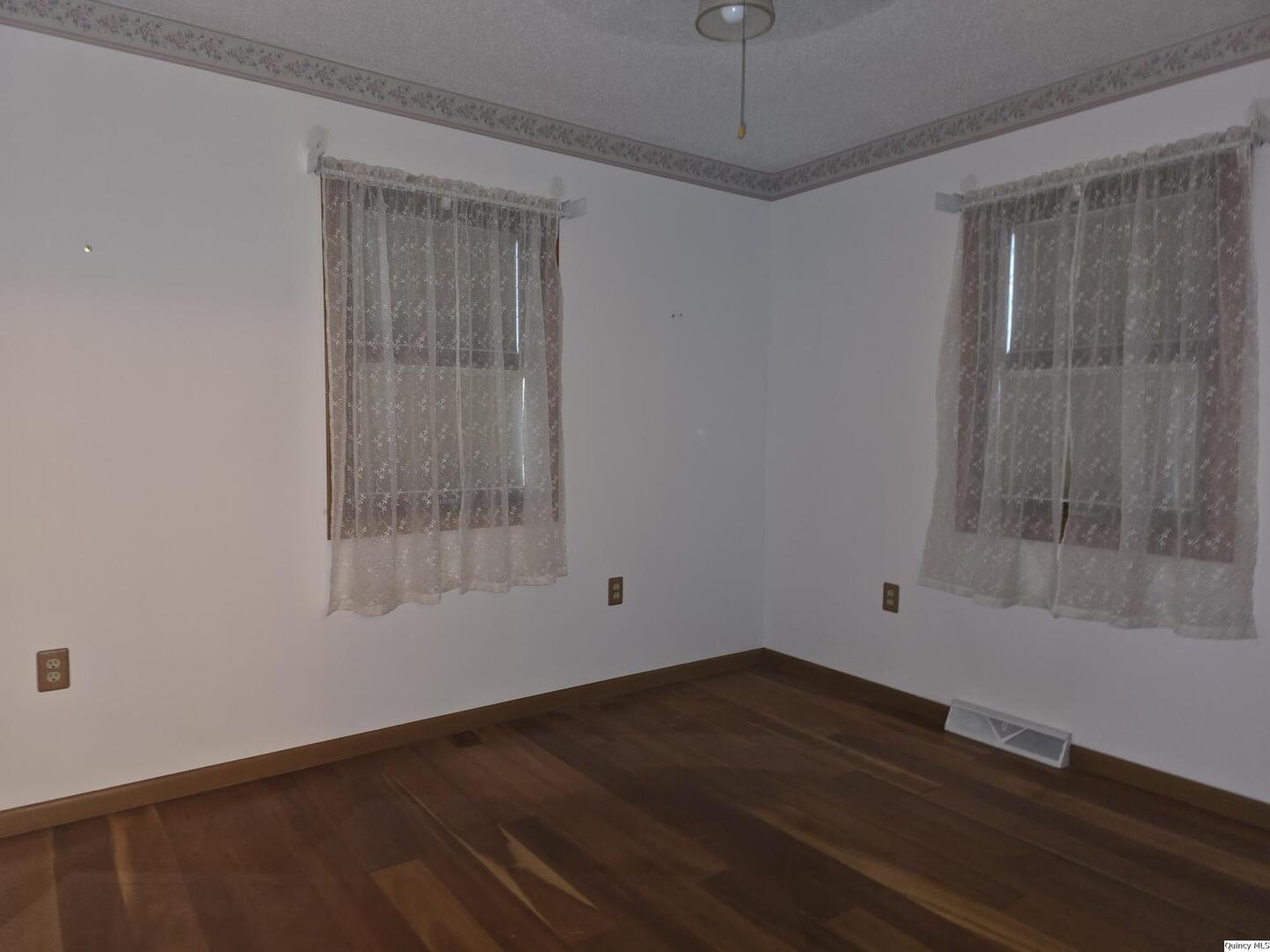239 Rogers Road Carthage, IL 62321 - Photo 15 of 23 an empty room with wooden floor and windows