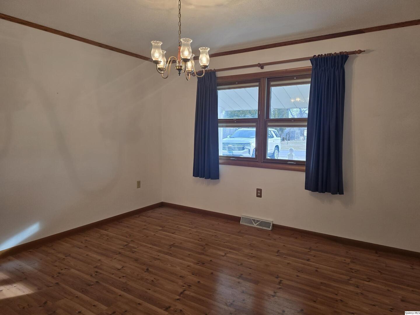 239 Rogers Road Carthage, IL 62321 - Photo 7 of 23 a view of an empty room with wooden floor and a window