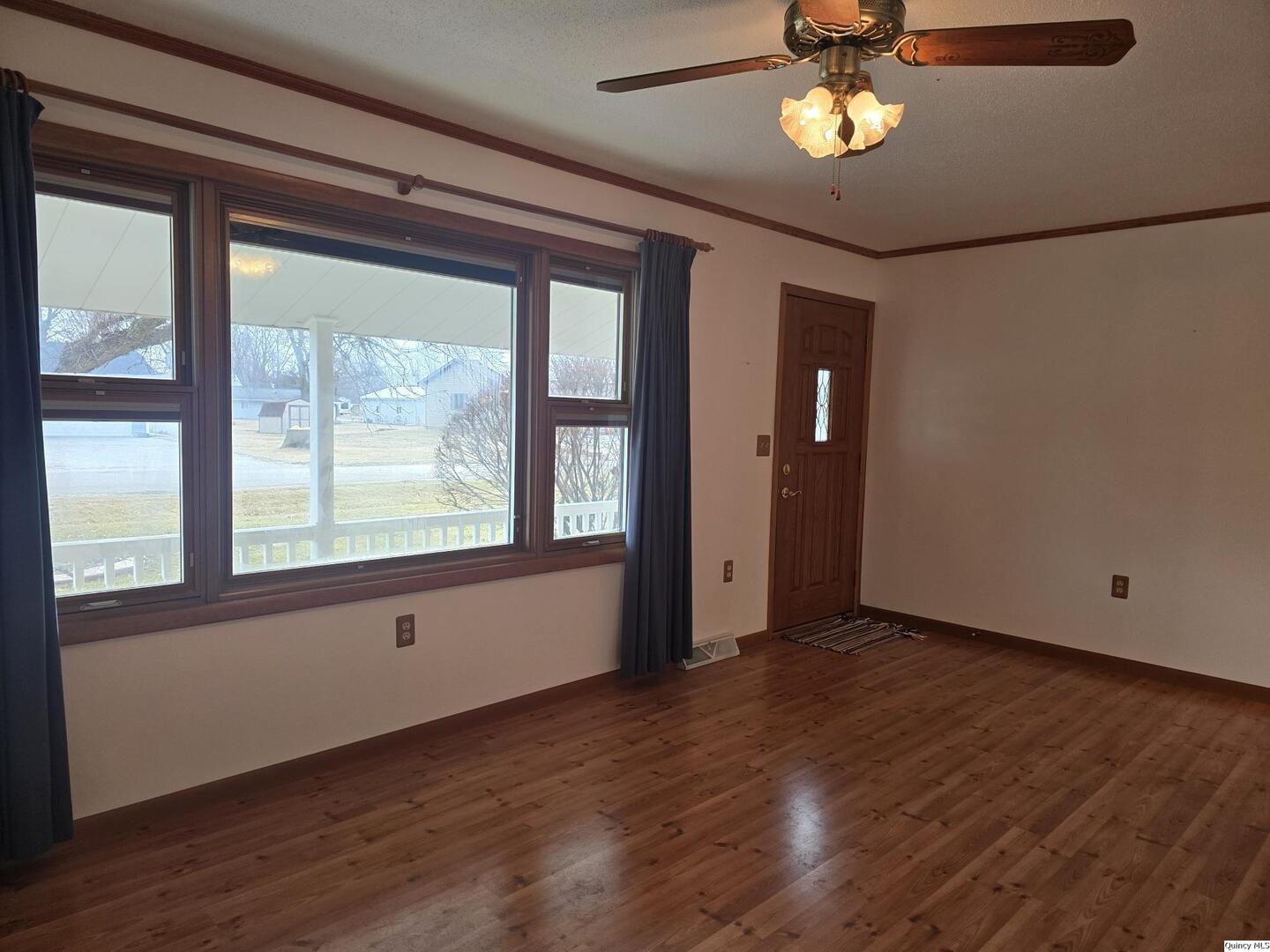 239 Rogers Road Carthage, IL 62321 - Photo 9 of 23 a view of an empty room with wooden floor and a window