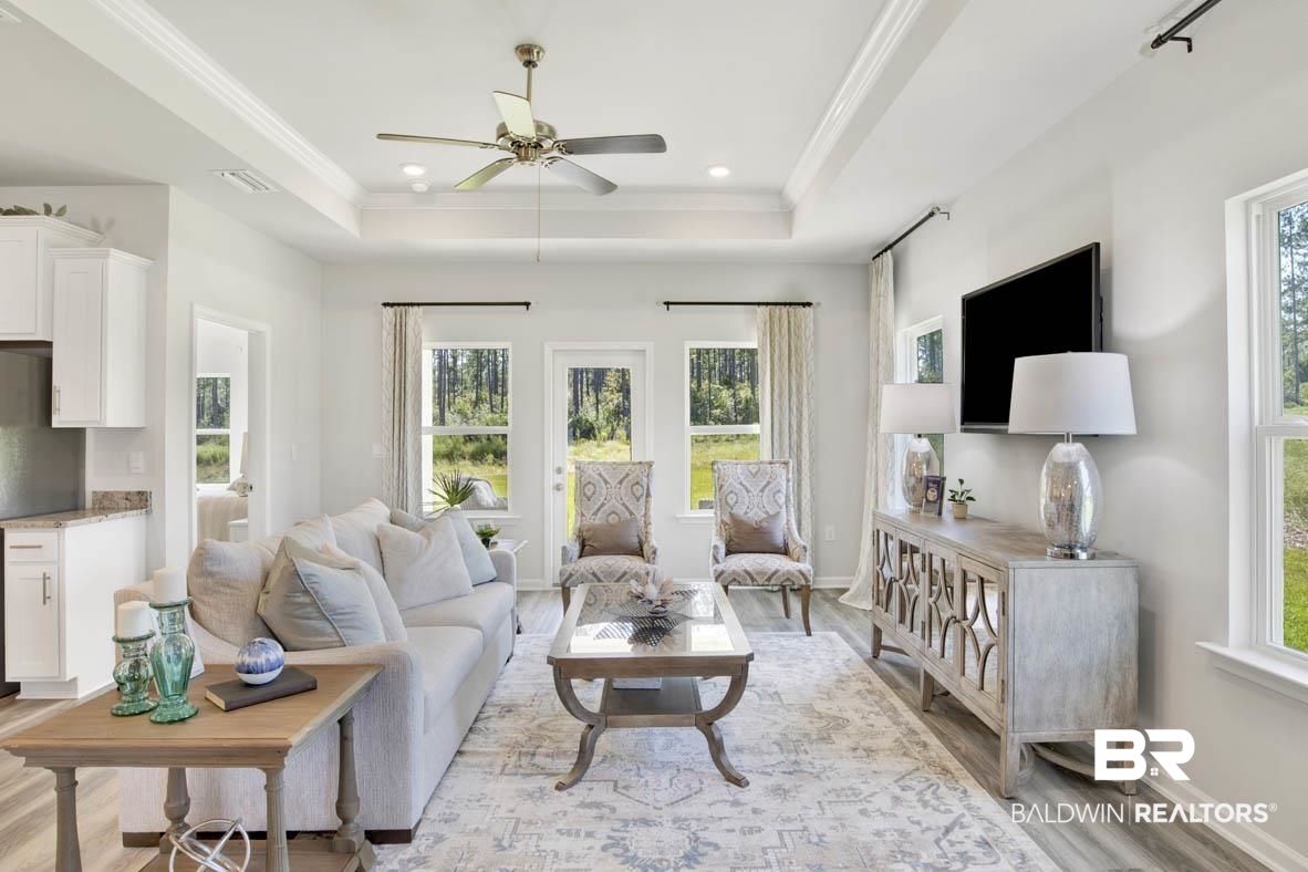 13822 Antler Hl Road Daphne, AL 36527 - Photo 26 of 39 Living room with ceiling fan, ornamental molding, light wood-type flooring, and a tray ceiling