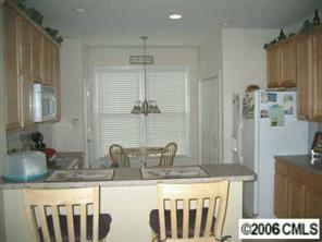 416 Third Baxter Street Fort Mill, SC 29708 - Photo 3 of 8 a kitchen with stainless steel appliances granite countertop a sink and a refrigerator