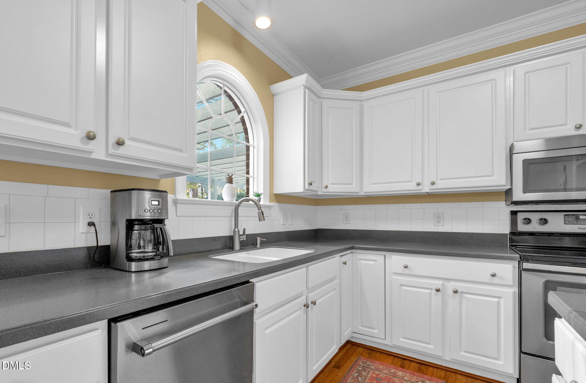 2605 Lizei Street Raleigh, NC 27616 - Photo 13 of 46 a kitchen with white cabinets and a sink